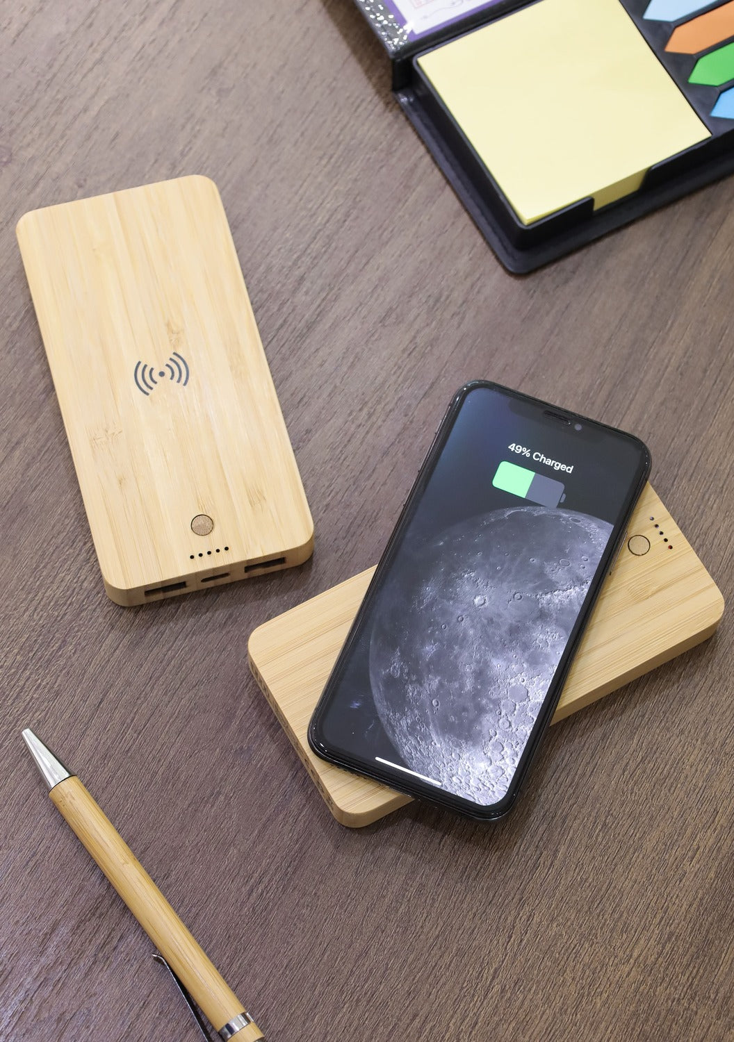 Wooden wireless charging pad with smartphone on a wooden surface