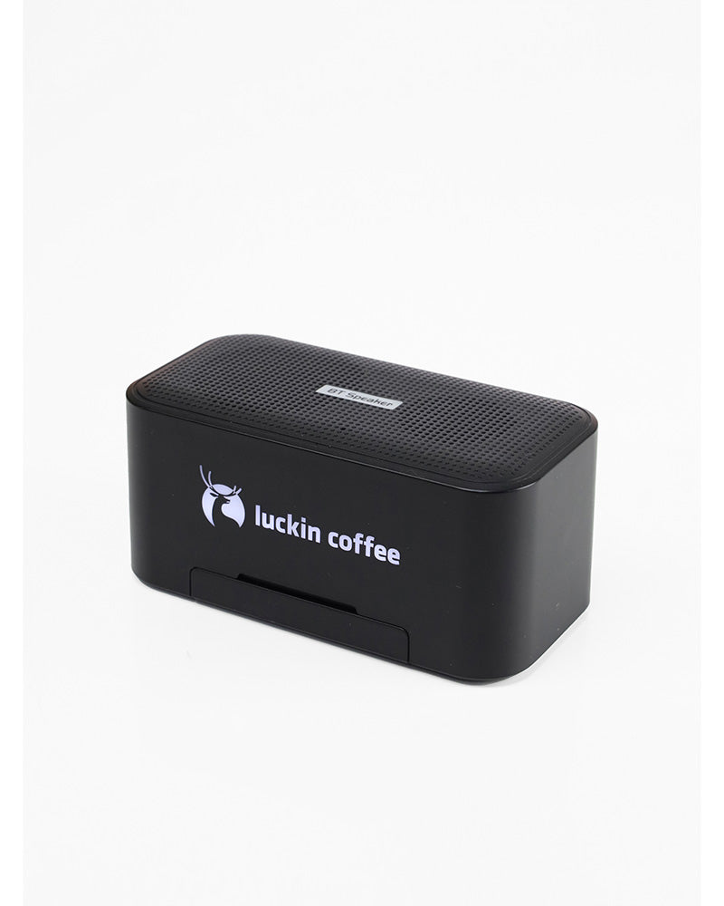 Black wireless speaker with a logo printed on the front.