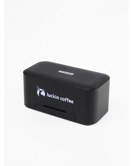 Black wireless speaker with a logo printed on the front.