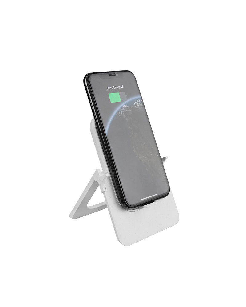 Smartphone on a white stand with charging indicator on a white background