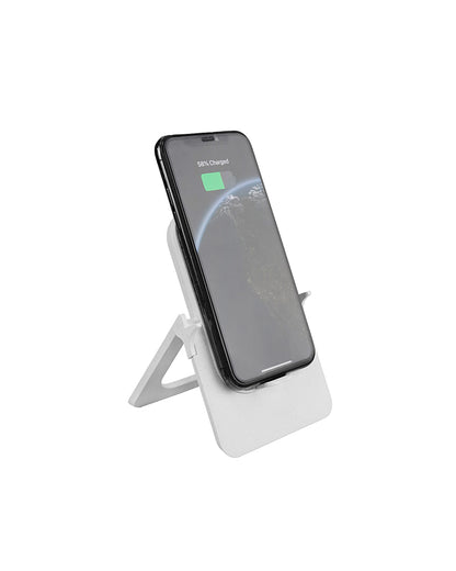 Smartphone on a white stand with charging indicator on a white background