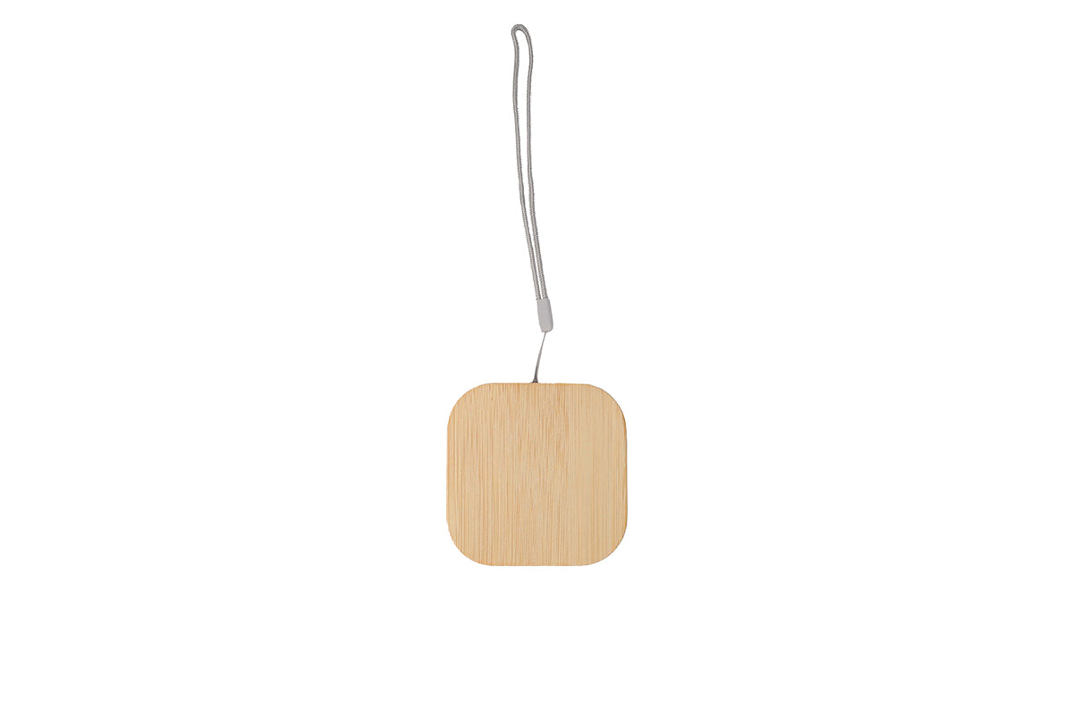 Square wooden ornament with a string on a white background