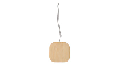 Square wooden ornament with a string on a white background