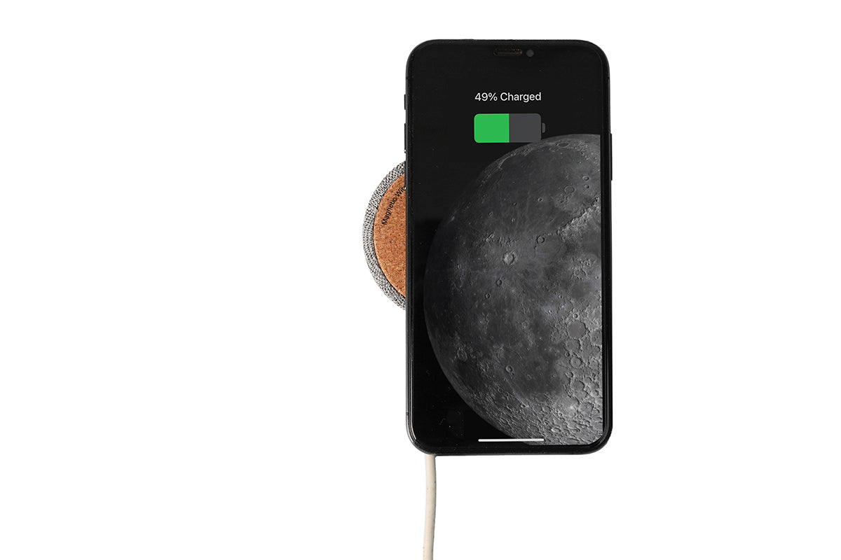Phone on a wireless charging pad with a white background