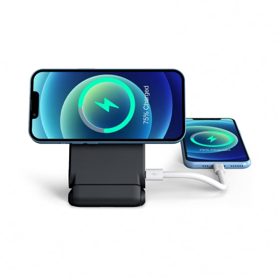 Two smartphones charging on a black stand with charging cables on a white background