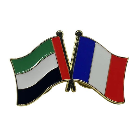 Pin with crossed flags of the United Arab Emirates and France on a white background