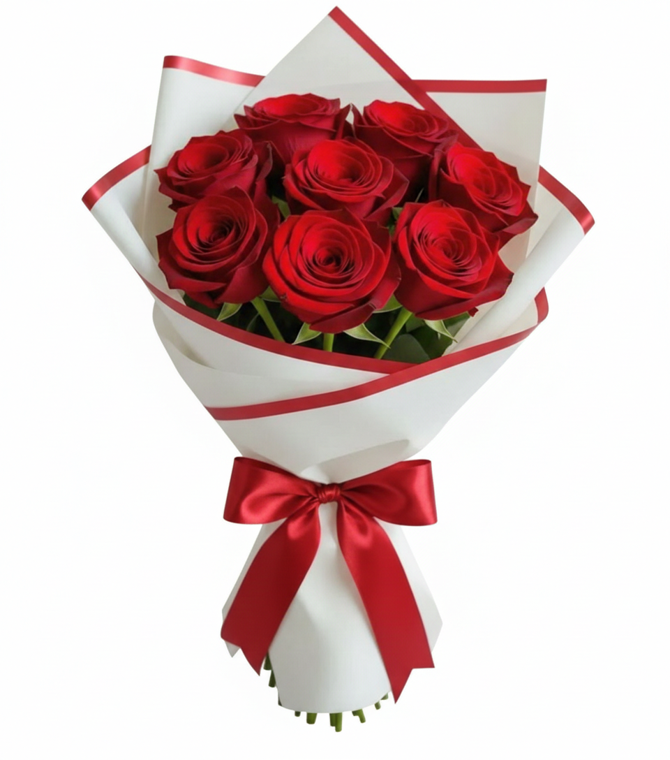 Bouquet of red roses wrapped in white paper with a red ribbon on a white background