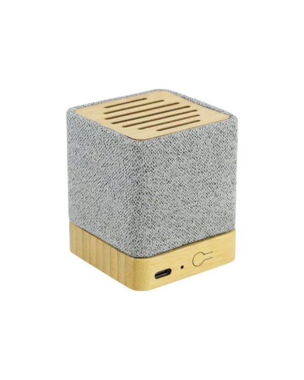 Cube-shaped speaker with textured gray top and wooden bottom on a white background
