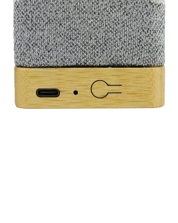 Close-up of a textured gray top and wooden bottom with USB port and power symbol on a white background