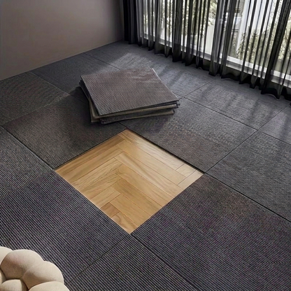 Gray floor tiles with a wooden square tile in a room with curtains.