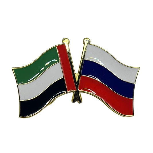 Pin with crossed flags of Umm al-Qura and Russia on a white background