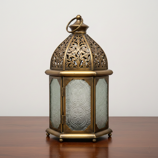 Decorative brass lantern with intricate designs on a wooden surface