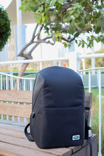 Black backpack with a visible brand logo on a wooden bench outdoors.
