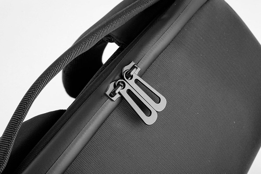Close-up of a black suitcase with a zipper on a white background