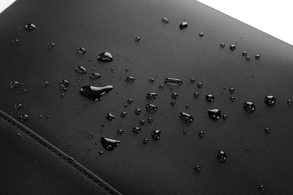 Water droplets on a black textured surface