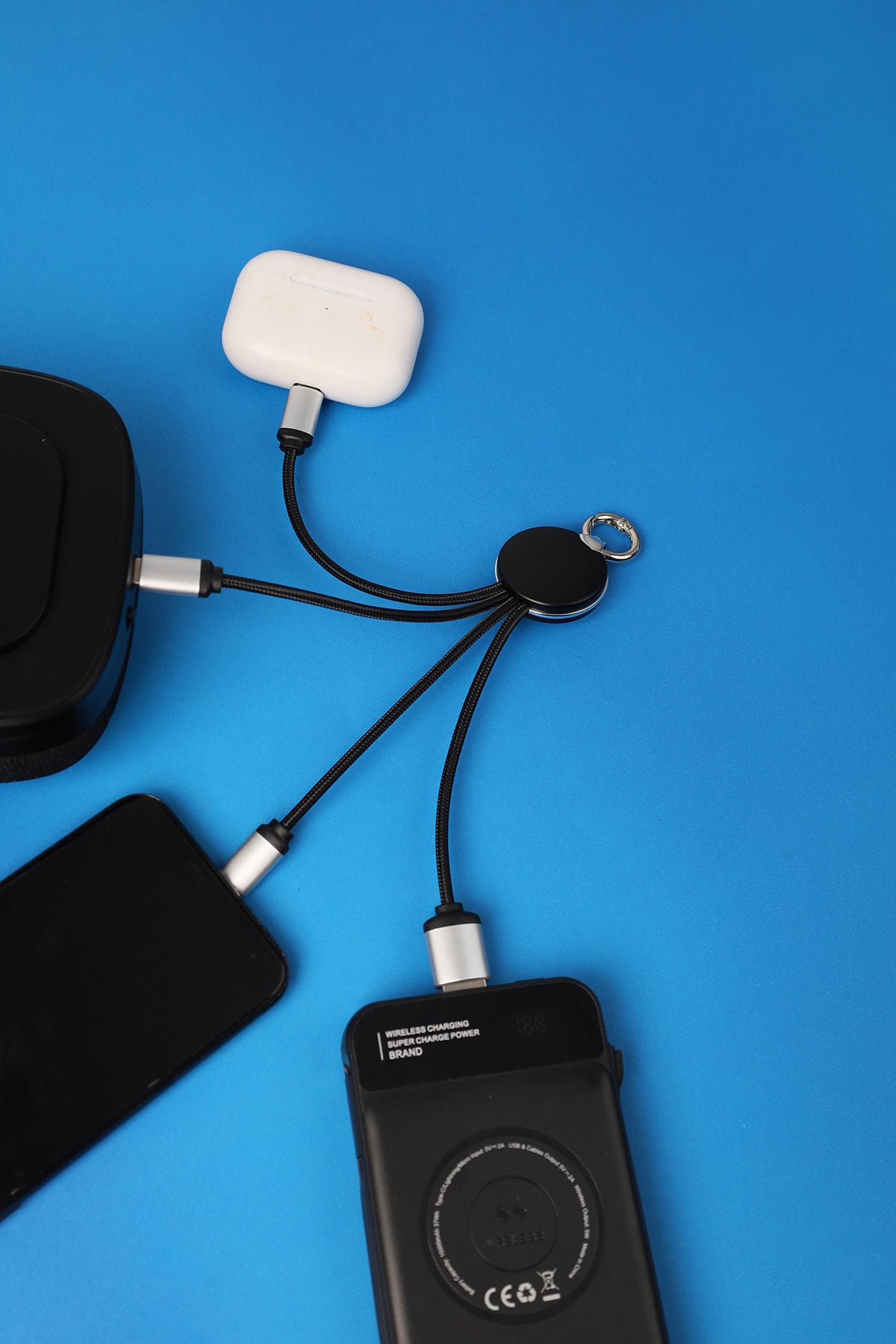 Black electronic device with multiple cables on a blue background