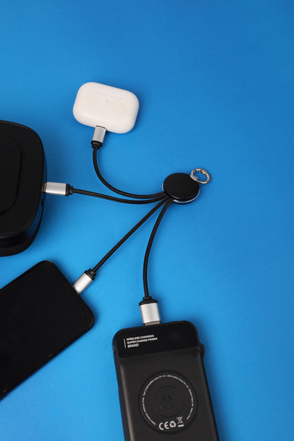 Black electronic device with multiple cables on a blue background