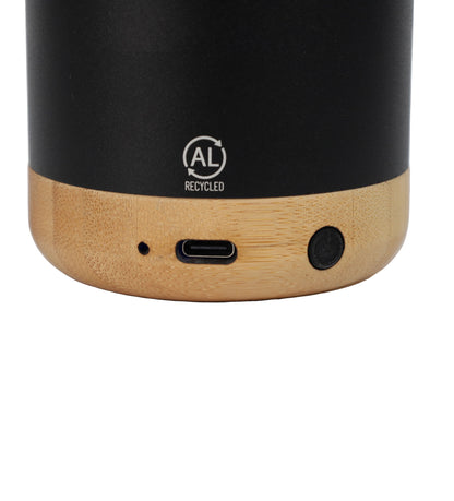 Black and wooden cylindrical speaker with USB port and AL Recycled logo on a white background