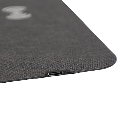 Close-up of a textured black surface with a USB-C port on a white background