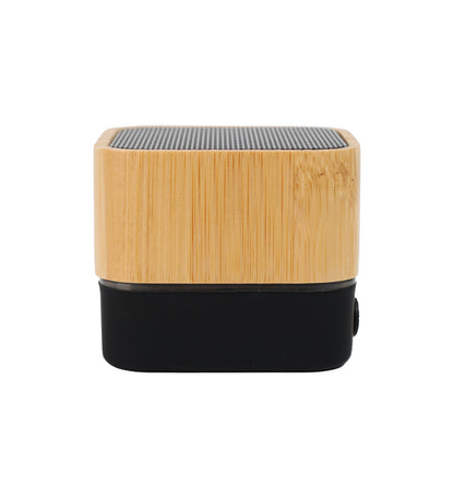 Small cube-shaped speaker with wooden top and black bottom on a white background
