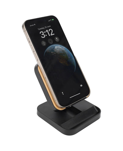 Smartphone on a black charging stand with a white background