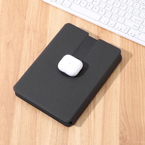 Black mouse pad with a white mouse on a wooden desk with a keyboard in the background