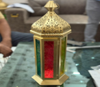 Decorative lantern with intricate designs on a blurred background