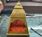 Decorative object with intricate design on a reflective surface