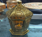 Decorative metal box with intricate designs on a table