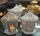 Decorative lanterns with intricate designs on a dark background