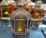 Decorative lantern with colorful glass panels on a black background