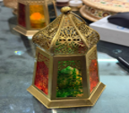Decorative hexagonal object with intricate design on a reflective surface