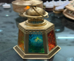 Decorative item with a colorful design on a metallic base