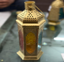 Decorative lantern with intricate design on a plain background
