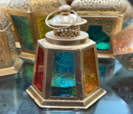 Decorative lamp with stained glass design on a reflective surface