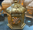 Decorative lantern with intricate designs on a white background