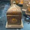 Decorative metal box with intricate designs on a reflective surface