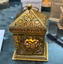 Decorative lantern with intricate design on a dark background