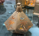 Decorative lantern with intricate designs on a dark background