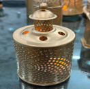 Ceramic lanterns with decorative elements on a reflective surface