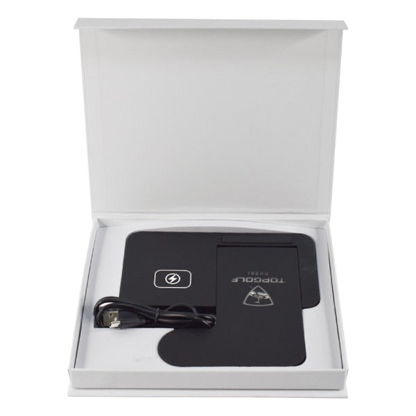 Black electronic device with a USB cable in an open white box