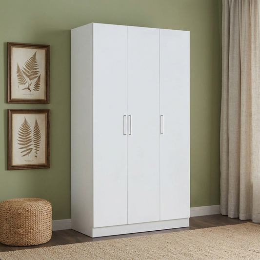 White wardrobe against a green wall with framed botanical prints and a woven stool.