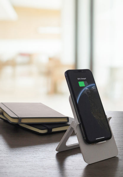 Smartphone on a stand with 'Wi-Fi' and 'Charging' indicators displayed.