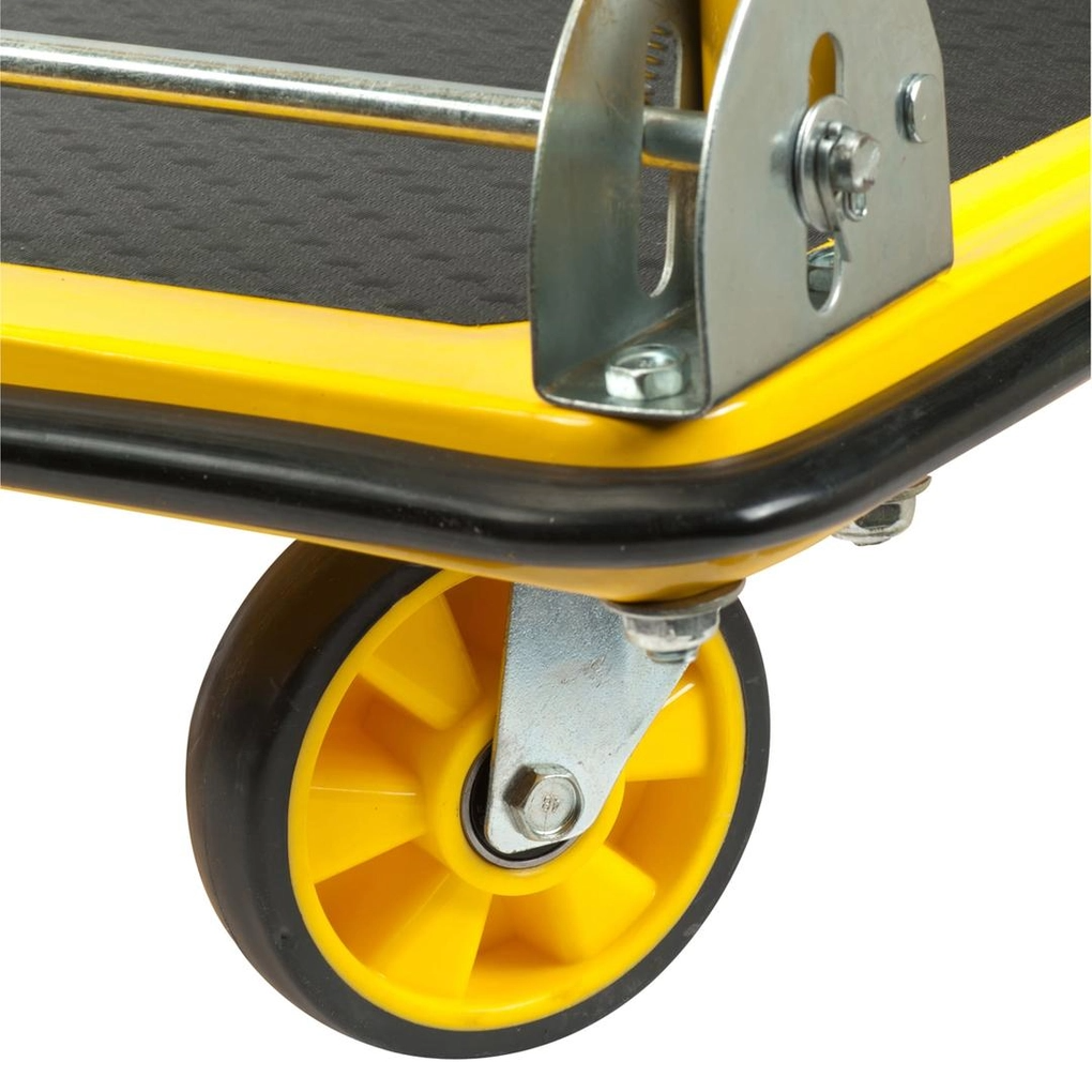 Close-up of a yellow wheel and metal bracket on a black surface