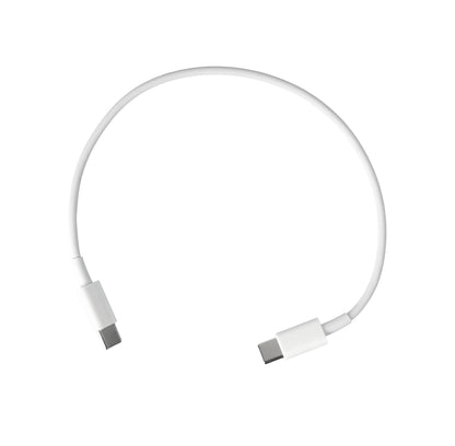 White travel-sized Mini Travel Cable Kit  with open lid on a brown surface